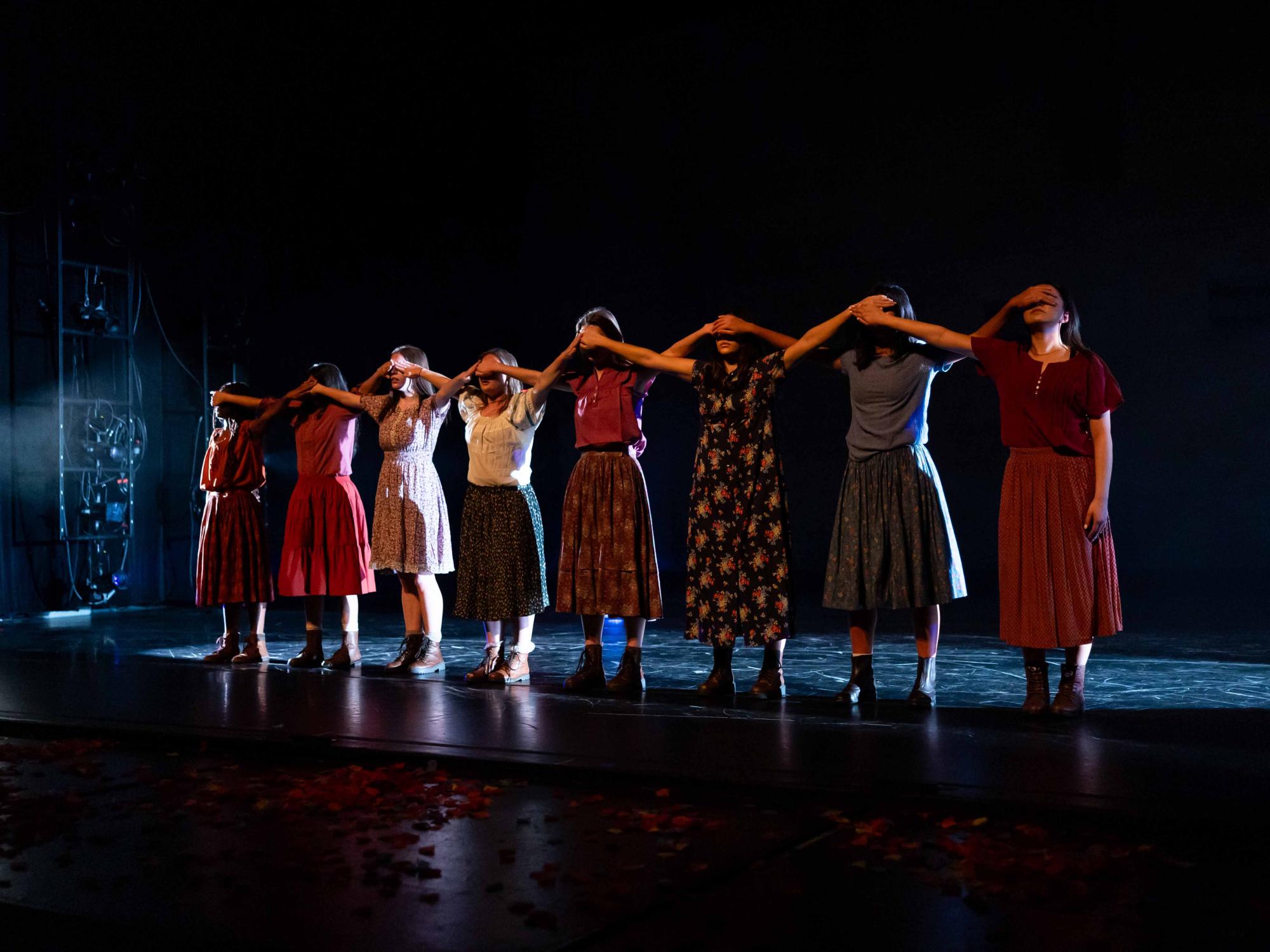Dancers within Motherless Child cover each other's eyes in a line.