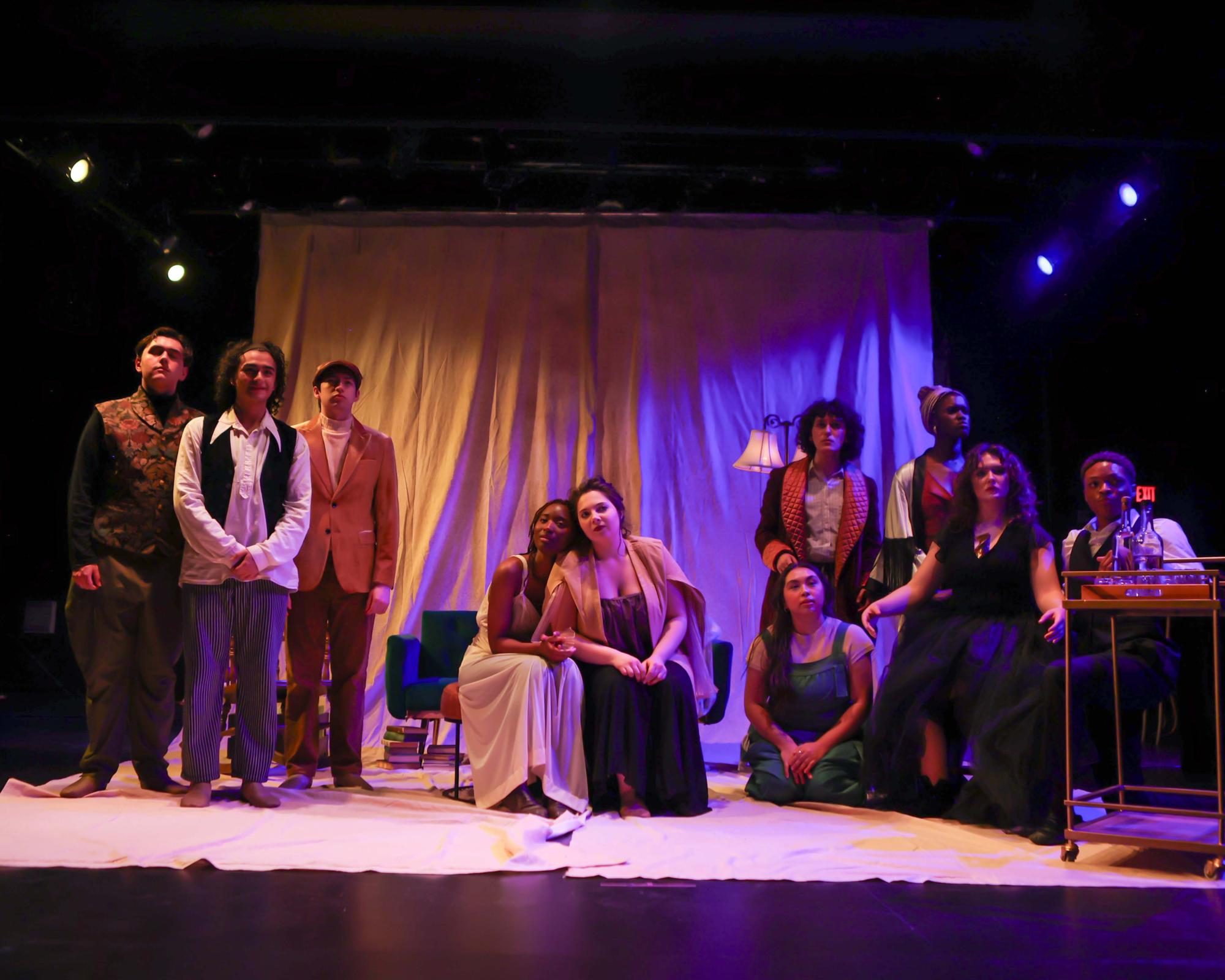 The entire cast sits on arranged on the stage performing a musical number. From left to right, Trigorin, Deigo Rodriguez, Treplev, Adam Flores Jr., Dorn, Roman Losa, Nina, Eian Johnson, Paulina, Emerson Hartman, Yakov, Esmeralda Trevino, Sorin, Zoey Gonzales, Arkadina, Oyin Ojomo, Masha, Mackenzie Mann, and Medved, Isaiah Jones.
