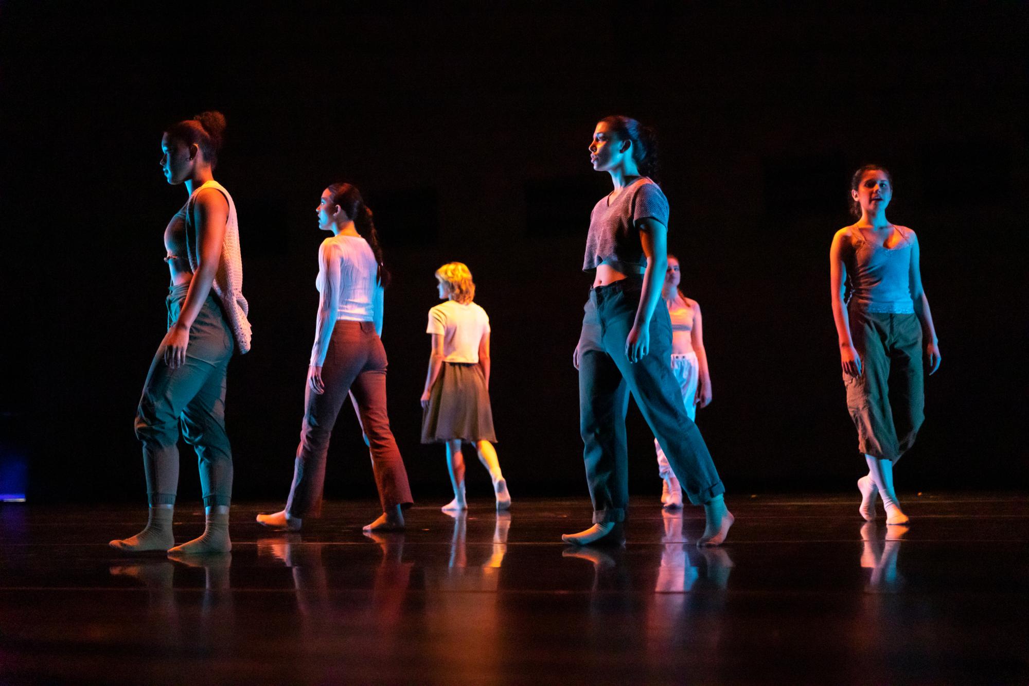 Facing different directions, the dancers are at a standstill