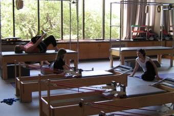 three dancers using equipment to stretch