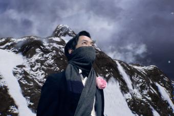 man with a scarf wrapped around his mouth and nose looks up, with an icy Antarctic background behind him