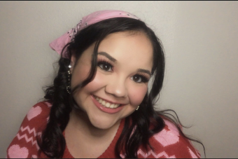 headshot of Hayley Carbajal wearing earrings and a pink headband