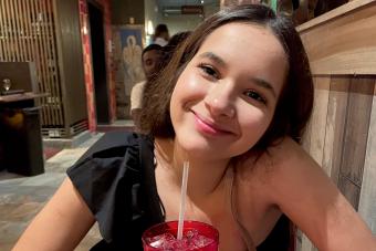 Victoria Vargas sitting with a red glass of water in front of her