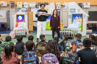 Mateo Hernandez and Roxanne Schroeder-Arce introduce THE SMARTEST GIRL IN THE WORLD to an audience of elementary school students