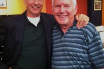 James Walters poses for a photo next to Mark Harmon
