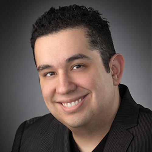 man in black blazer smiling